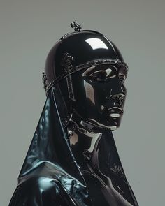 a black and silver statue with a crown on it's head