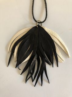 A beautifully white and black colored lambskin leaf leather necklace. Gorgeously comfortable and easy to wear. string is made from leather. Color might be altered due to the lighting of the photo taken. Handmade White Leather Jewelry, Handmade Black Leather Necklace, Polymer Crafts, Wedding Jewellery Necklace, Leather Necklace, Special Design, Leather Jewelry, Wedding Necklace, Tassel Necklace