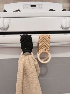 an oven door handle with two rings hanging from it's front and back handles