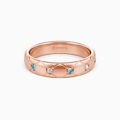 a rose gold wedding band with blue stones