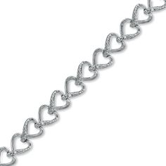 This charming bracelet is perfect for the passionate woman who wears her heart on her sleeve. This sweet style showcases a lovely chain of linked hearts tenderly crafted in fine sterling silver. Understated accent diamonds are lightly sprinkled on one side of each heart. This delightful 1/15 ct. t.w. diamond accessory measures 7.0 inches in length and secures with a lobster claw clasp. Silver Heart-shaped Diamond Bracelet For Formal Occasions, Sterling Silver Heart-shaped Bracelet In White Gold For Anniversary, Silver Heart Bracelet With Diamond Accents, Silver Heart-shaped Diamond Bracelet With Accents, Silver Heart Diamond Bracelet, Silver Heart Shaped Diamond Bracelet With Accents, Silver Heart Shaped Diamond Bracelet, Silver Diamond Heart Bracelet For Valentine's Day, Heart-shaped Silver Bracelets With Diamond Accents