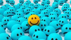 a smiley face surrounded by blue balls with one yellow ball in the middle and several others