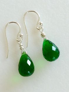 "Gorgeous faceted Emerald green Quartz teardrops wire wrapped in Sterling silver. Lush green briolettes measure 9 x 13 mm and hang from simple classic Sterling silver French ear hooks. They measure 1 1/8\" long. Beautiful May birthstone earrings!" Green Wire Wrapped Long Drop Jewelry, Green Teardrop Earrings For Jewelry Making, Green Teardrop Drop Earrings For Jewelry Making, Green Teardrop Jewelry With Ear Wire, Green Teardrop Drop Earrings Nickel Free, Green Teardrop Earrings For May Birthstone, Green Wire Wrapped Teardrop Jewelry, Green Teardrop Wire Wrapped Jewelry, Green Teardrop May Birthstone Earrings