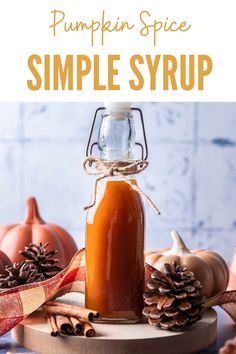 pumpkin spice simple syrup in a glass jar with pine cones on the side