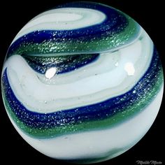 a glass ball with blue and green swirls on it