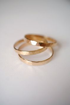 three gold rings sitting on top of each other