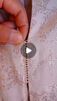 someone is stitching the side of a dress