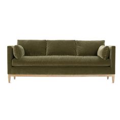 a green couch with two pillows on it