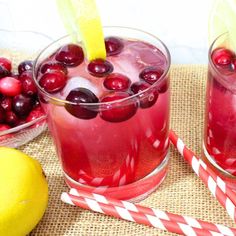 two glasses filled with cranberry lemonade on top of a table