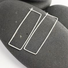 "These silver and 14K white gold rectangle hoops have been hand formed and hammered for strength and a subtle texture that sparkles. The posts tuck into a loop catch on the backside of the earring, so there's no risk of losing backs. Modern, elegant, feminine and bold, these earrings are always in style and will always match. This particular pair of earrings from the line is a long rectangle - 1 7/8 inches long and about 5/8\" wide. Made from responsible and recycled metals - sterling silver and Elegant Feminine, Earrings Geometric, Recycled Metal, Subtle Textures, Minimalist Earrings, Sterling Silver Earrings, Silver Earrings, Sparkle, White Gold