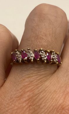 This is a vintage red ruby with tiny diamonds ring set in gold 925 sterling silver set in a lovely pattern. Size 8 this can be sized to your specification, please message us to discuss sizing your ring or engraving options. Sizing costs $20, engraving $4 per letter. All of our jewelry is hand polished and shipped to you in a stylish gift box. We are happy to gift wrap for you. It is important to us that each customer be thrilled with their purchase. We are grateful for thousands of positive revi Classic Red Rings With Diamond Accents, Red Marquise Ruby Ring With Prong Setting, Fine Jewelry Red Diamond Ring Stamped 14k, Hallmarked Red Ruby Ring In 14k Gold, Antique Red Diamond Ring With Gemstone, Antique Red Rings With Prong Setting, Red Ruby Diamond Ring Hallmarked, Antique Red Ring With Prong Setting, Vintage Red Ruby Ring For Anniversary