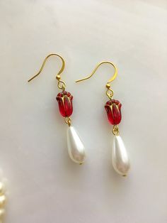 Handmade Victorian style glass pearl drop earring with red Czech glass flowers. The earrings measure approximately 2" long. Red Pearl Drop Earrings As Gift, Handmade Victorian Pearl Earrings For Gifts, Red Pearl Drop Earrings For Gift, Victorian Pearl Drop Earrings For Gift, Red Teardrop Pearl Drop Earrings, Victorian Style Dangle Earrings With Pearl Drop, Handmade Victorian Drop Earrings, Victorian Style Handmade Gold Pearl Earrings, Victorian Drop Earrings