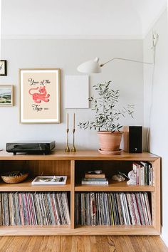 an entertainment center with record players and records