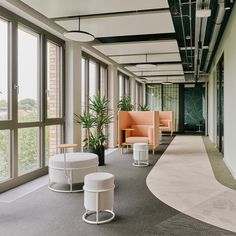 an office with large windows and seating area