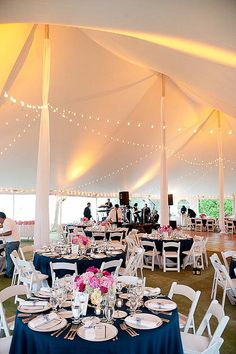 a large tent with tables and chairs set up for an event