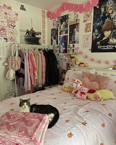 a cat laying on a bed in a bedroom