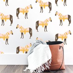 a brown and white horse wallpaper next to a bag with a blanket on it