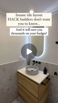 a bathroom with a sink, mirror and toilet paper dispenser in it