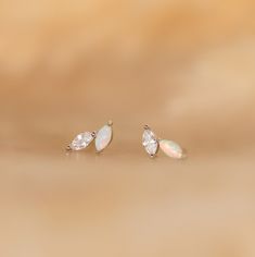 If elegance is your goal, look no further than our Opal & Diamond Marquise Studs. With their mismatched design and delicate nature, these earrings add a touch of uniqueness while still remaining classic. Give as a meaningful gift to your bridesmaids so they may all remember the special day. Material: High Quality Solid 925 Sterling Silver Finish: 18K Gold ∙ Sterling Silver Featuring ~5x2mm Marquise Opal & Diamond Gemstones Sold as a pair Part of our Opal Collection Model showcases a understated, Silver Fine Jewelry Ear Climbers For Wedding, Minimalist Sterling Silver Ear Climbers For Wedding, Dainty White Sterling Silver Bridal Earrings, Delicate Gemstone Earrings For Wedding, White Gold Sterling Silver Ear Climbers For Wedding, Wedding Sterling Silver Ear Climbers Fine Jewelry, Wedding Sterling Silver Ear Climbers, Wedding Fine Jewelry Sterling Silver Ear Climbers, White 14k Gold Bridal Earrings