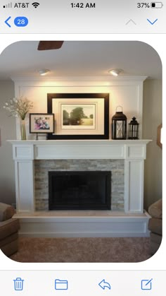 a living room with a fireplace and pictures on the mantle