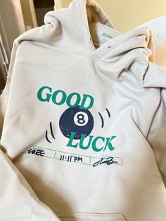 Good Luck 8 Ball Hoodie Pullover hoodie material is 50/50 cotton and polyester. Each item is uniquely printed and designed by me. Black/Green ink on Beige Clothing Unisex Sizing, S, M, L, XL Available (Message me for XXL+ Sizing) Wash instructions: Turn inside out, wash with cold water and delicate setting. Air dry preferred. Follow specific care instructions to ensure the longevity of the design for all handmade items. Check out my Instagram and Depop for customer photos and reviews. Message me Words On Hoodies, Cute Senior Hoodies, Original Hoodie Design, 8 Ball Sweatshirt, Cute Crewneck Sweatshirt Design, Disco Ball Clothes, Merch Ideas Hoodies, Graphic Hoodie Design Inspiration, Christmas Gift Ideas Clothes