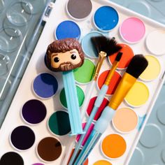 some paint brushes and a bob ross face on it