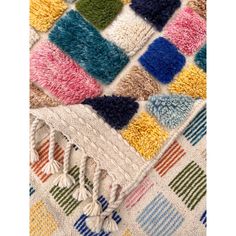 multicolored rug with fringes and tassels on the edges, close up