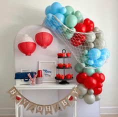 a table with balloons and decorations on it