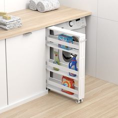 an open cabinet in the corner of a kitchen with towels and other items on it