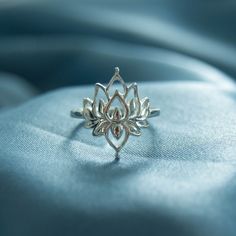 .925 sterling silver Designer's Notes This sterling silver Lotus Ring is named for the Sanskrit word for lotus, "पद्मा" or "padma." The Lotus is the most sacred flower, symbolizing ultimate beauty and new beginnings. This most beautiful of flowers performs a little miracle every day as it grows out of the mud to bloom so beautifully. The mud represents the struggles of life, the blooming is your strength in overcoming the struggle and thriving.It's a perfect self gift or gift for a friend as a r Sacred Flower, Self Gift, Lotus Ring, Talisman Jewelry, Sanskrit Words, Street Dogs, Jewelry Tags, The Lotus, Lost Wax Casting