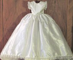 "REASONABLE OFFERS CONSIDERED   New Old Stock-  Excellent Condition need cleaning? tiny spot on back of train (see last 2 photos)   Vintage 80's Doll Dress Sleeveless Bright White Satin & Lace Wedding. Dress has lace trim accent bottom & around sleeves, 3 snap closure in back, 2 layers of crinoline under skirt.  Approx measurements (LAYING FLAT)     DRESS                                                   front length 17 inches                                back length 23-1/2                                      waist 5-1/2 shoulder to waist 6 inches Condition: New: A brand-new, unused, unopened, undamaged item (including handmade items). See the seller's ... Read moreabout the condition Unit of Sale:Lot Antique:No Clothing Type:Dress Occasion:Wedding Number of Pieces:1 Color:White Doll Ty Cream Sleeveless First Communion Dress For Wedding, Fitted Sleeveless Cream First Communion Dress, Cream Sleeveless Fitted First Communion Dress, Sleeveless Fitted First Communion Dress With Lace Trim, Sleeveless White Baptism Gown, Fitted Sleeveless Gown For First Communion, Fitted Sleeveless Baptism Gown, Satin Lace Wedding Dress, Vintage Doll Dress