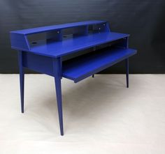 a blue desk sitting on top of a white floor