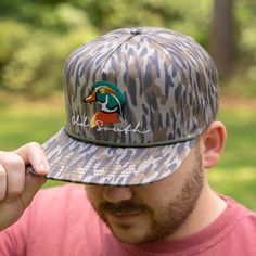 Keeping the hot southern sun out of your eyes and away from your face is important during the heat of June, July and August--both for guys and gals. Our classic, wide-brimmed trucker hat subtly announces your southern roots while shading your head and face. Crown: Structured Pro Crown | Pro-Stitched Finish | Adjustable Snap-Back Visor: Pre-Curved | Curved or Flat - Shape It How You WantSweatband: 3-Part Comfort Cotton FitClosure: Plastic Adjustable Snap-Back Sizes: Adult | One Size Fits Most Camo Trucker Hat, Duck Head, Camo Hat, Wood Duck, Suns Out, Wood Ducks, Camo Hats, Flat Shapes, Snap Backs