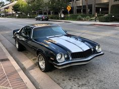 a black and silver car parked on the side of the road