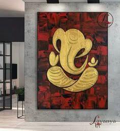 an elephant painting on a wall in a room with red and gold paint, it looks like the face of a god