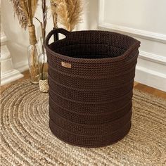 a brown basket sitting on top of a rug