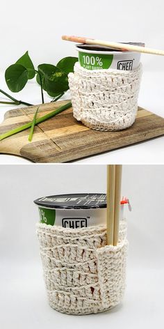 two baskets with chopsticks in them sitting on top of a wooden cutting board