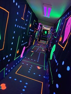 the hallway is decorated with neon lights and black walls, along with polka dot flooring