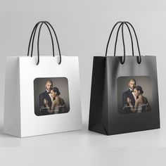 two black and white shopping bags with an image of a couple