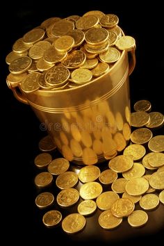 a bucket full of gold coins on a black background royalty images and stock photos for sale