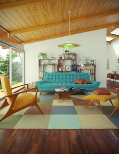 a living room filled with furniture and lots of windows