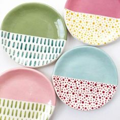 four plates with different designs on them