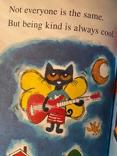 an open children's book with a cartoon cat playing the guitar and singing on it