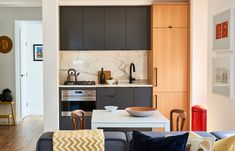 a kitchen and living room are separated by an open floor plan