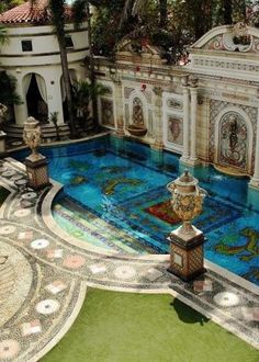 an outdoor swimming pool in the middle of a garden with lots of trees and plants