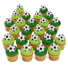 cupcakes with green frosting and soccer balls on them are arranged in a pyramid