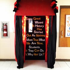 a red and black booth with writing on it's side in front of a door