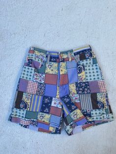 "Vintage 1980's-1990's shorts in a faux pastel patchwork print. High waist and cuffed leg. Metal zipper fly and button closure. No back pockets. Excellent vintage condition! label: Match; made in the U.S.A. fabric: cotton size: labeled size is 10. Please check measurements for an accurate fit. Questions are welcome! Shorts were measured across the front side lying flat. waist 13 1/2\" hips 37\" rise 13\" inseam 5 1/2\" outer length 17\"" Happy Spell, 1980s Fashion Women, White Lace Maxi Dress, White Lace Maxi, 90s Shorts, Patchwork Shorts, Shorts Cotton, Patchwork Print, High Waist Shorts