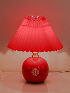 a red lamp sitting on top of a table