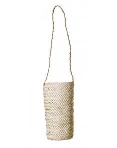 a small white basket hanging from a rope